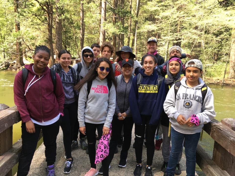 Longfellow Middle School students on a bridge over a river in Yosemite