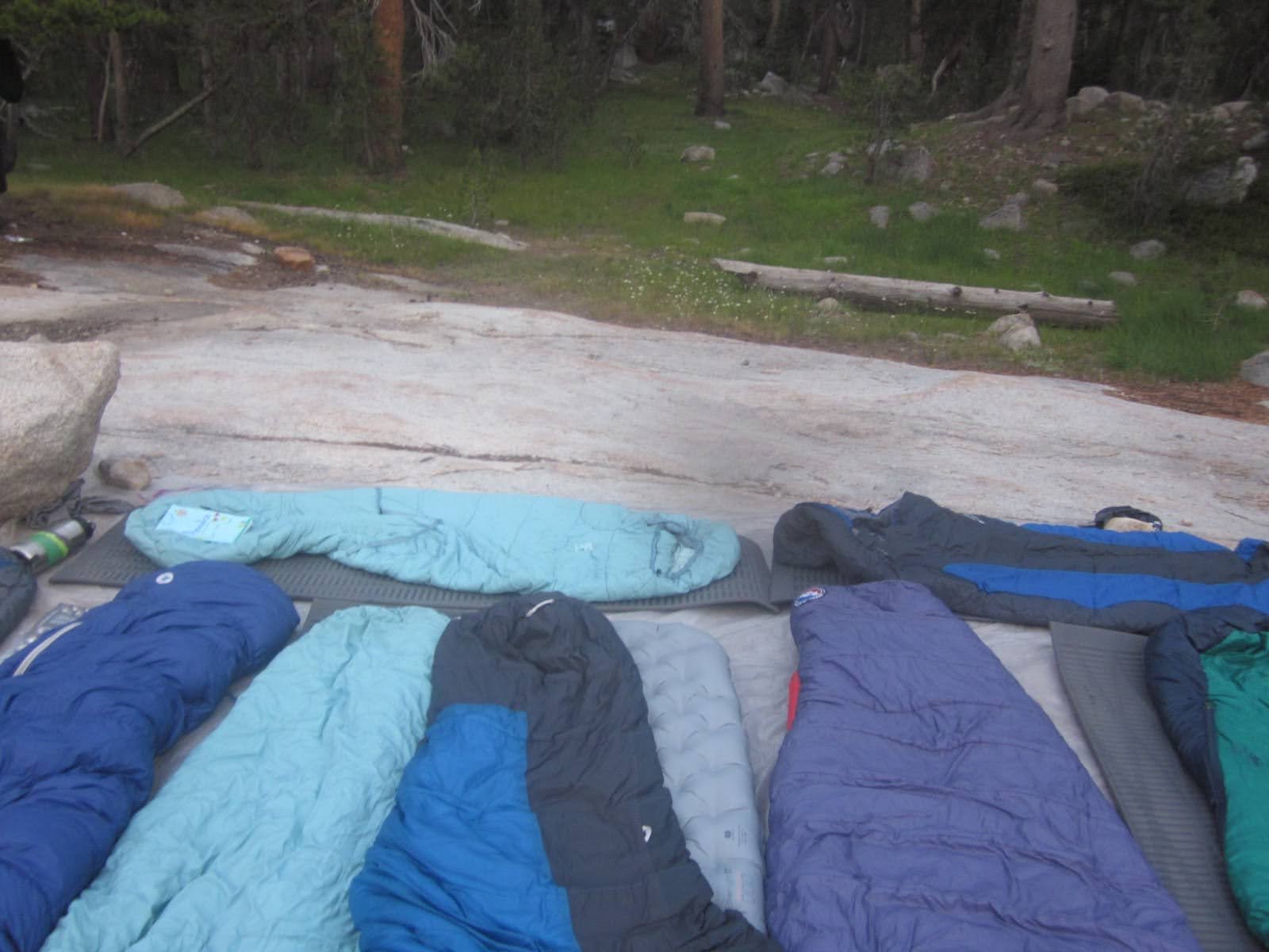 Line of sleeping bags set up outdoors