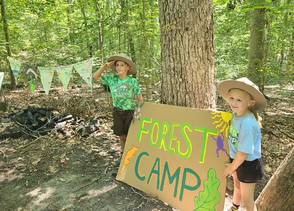 Forest Camp students with the Forest Camp sign