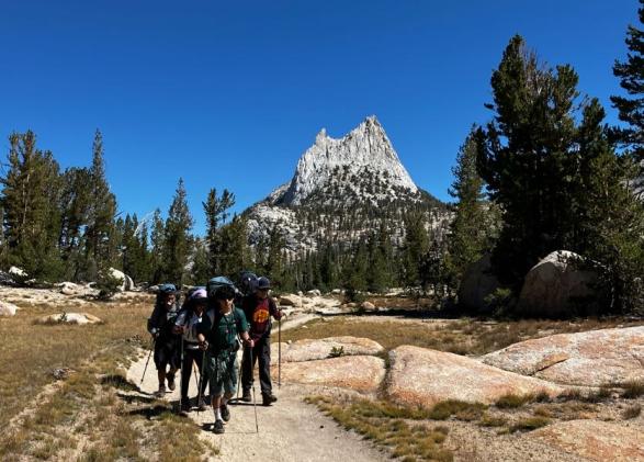 Venture Academy Students backpacking with Cathedral Peak in the background. 