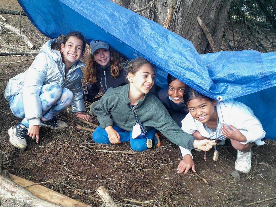 Coastal Camp students playing under a tarp