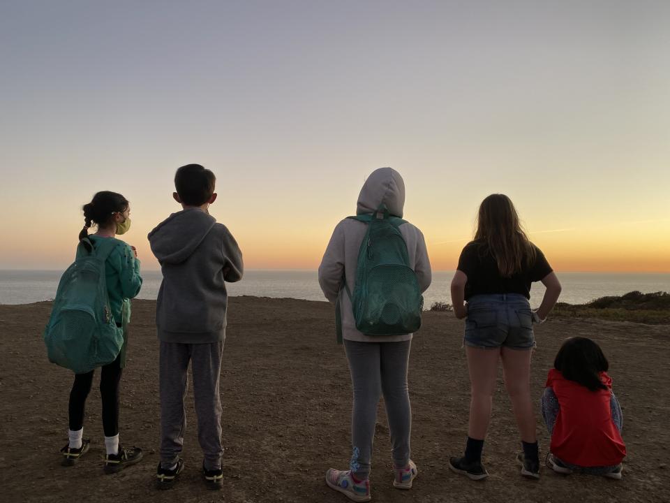 June Lifland and classmates watching the sunset over the ocean.
