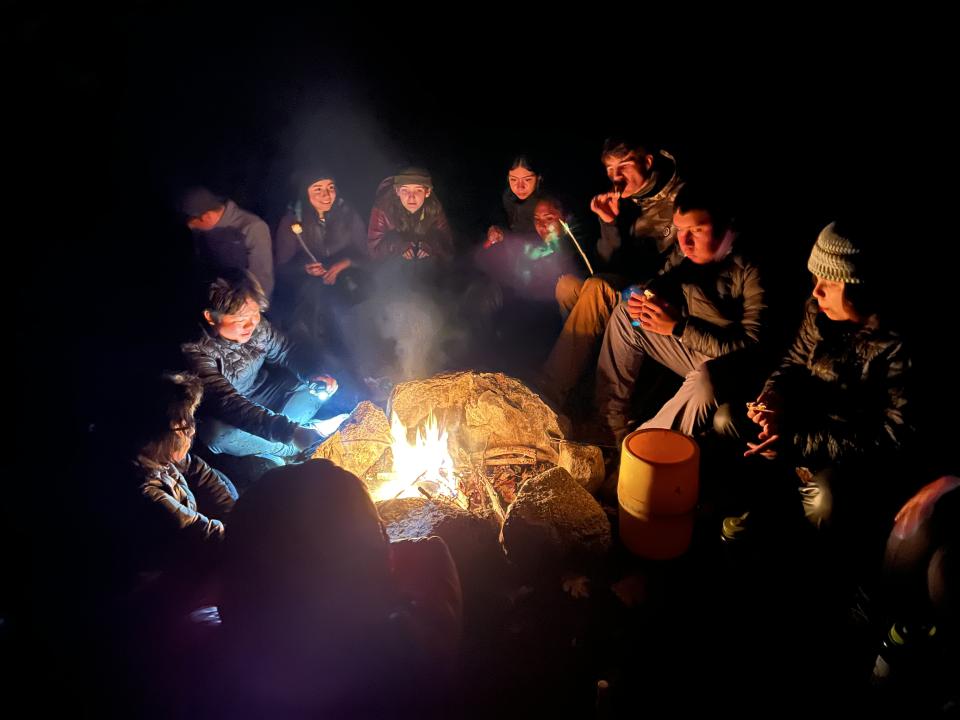 Students around a campfire during a WildLink program