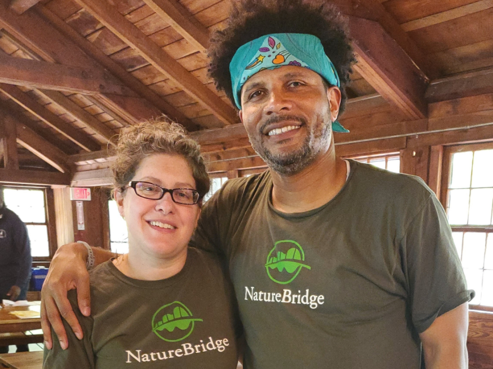 Mr. Brown and Mrs. Schubert posing in NatureBridge shirts