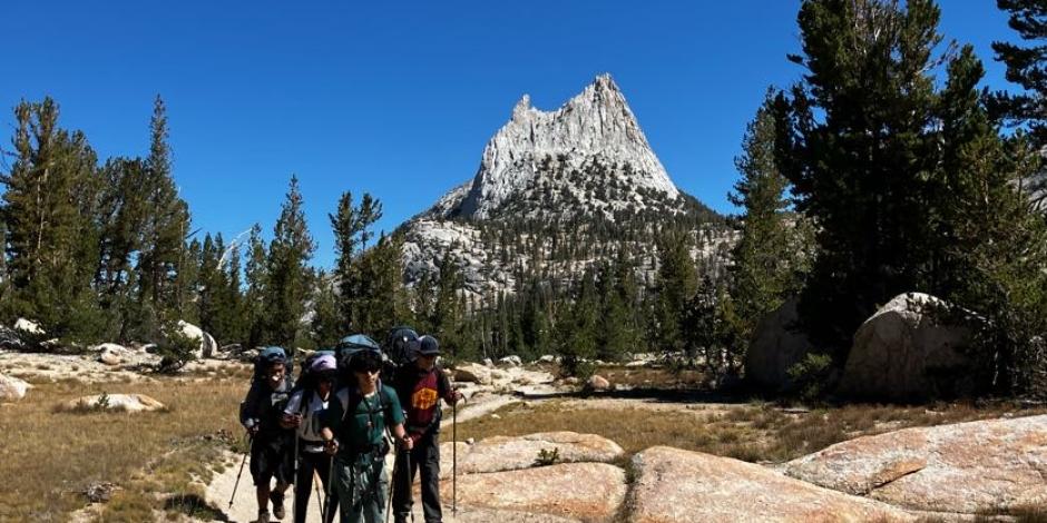 Venture Academy Students backpacking with Cathedral Peak in the background. 