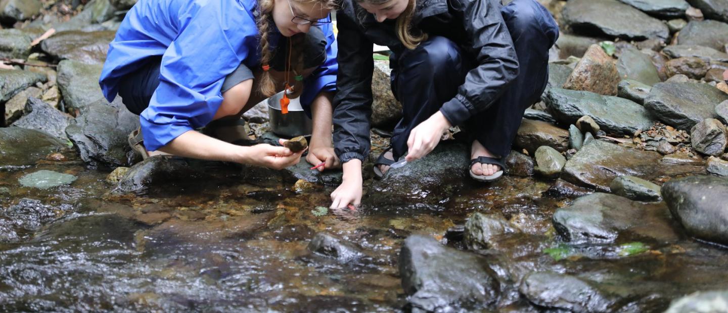 Two female students looking into stream