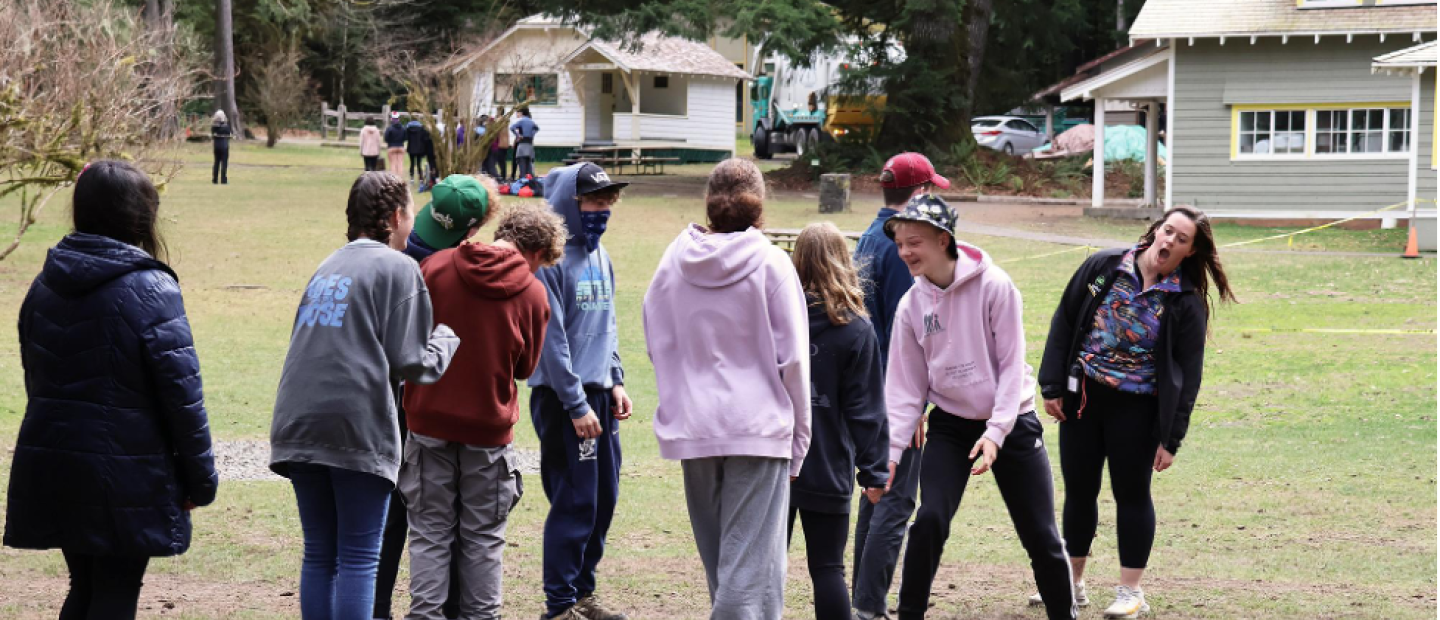 Students participating in a team-building exercise with a NatureBridge educator